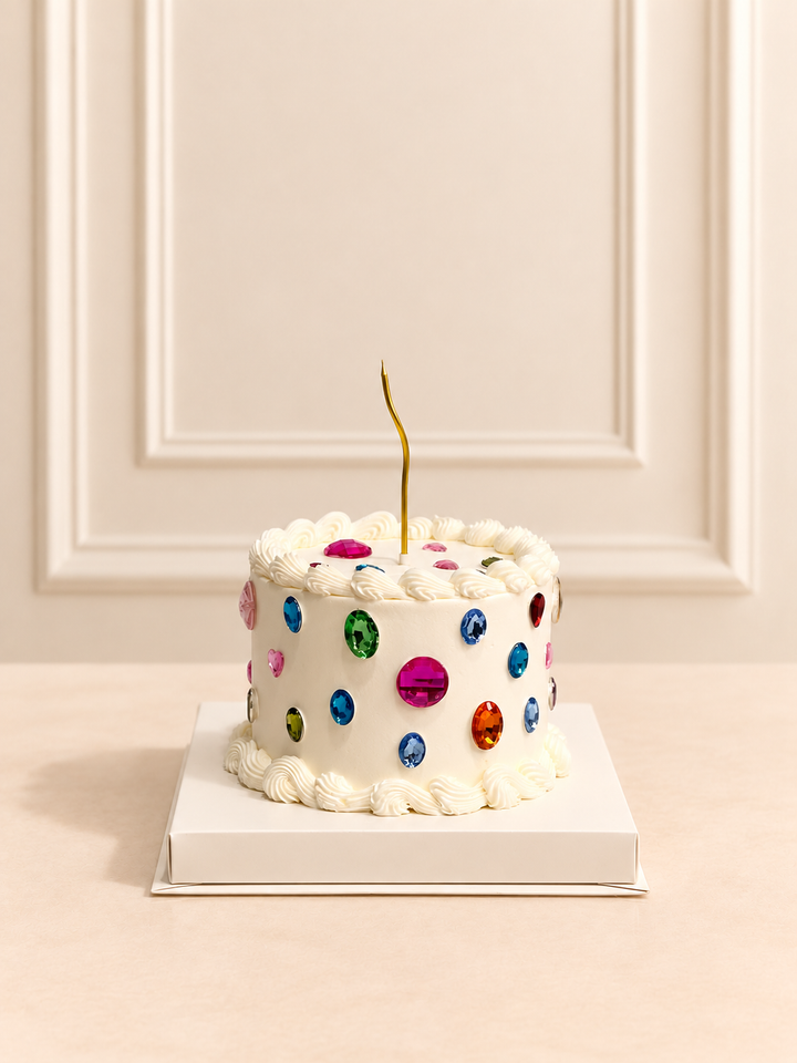 Bedazzle Gems 15 cm cake with colorful decorative gems and gold candle